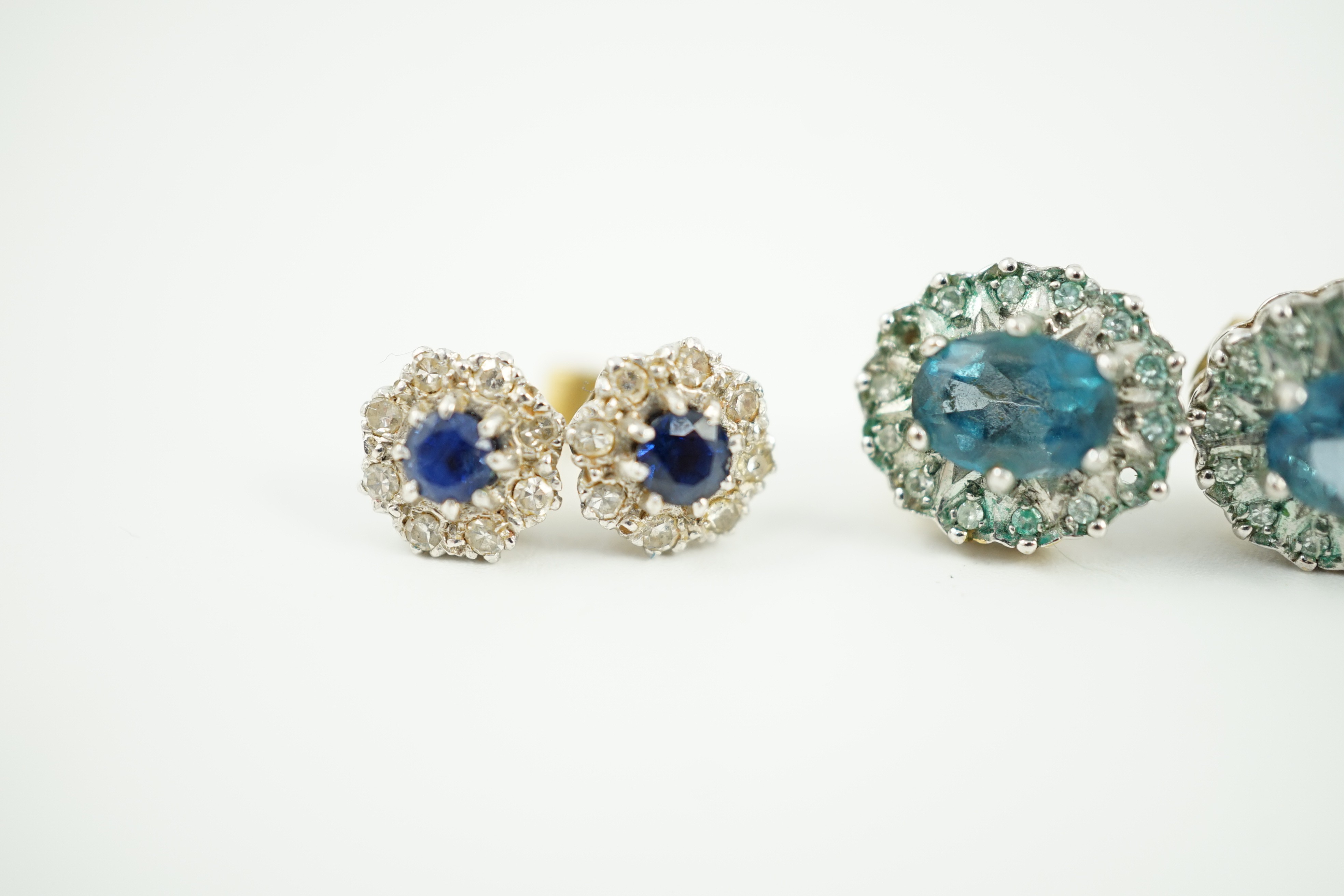 A modern pair of 18ct gold, sapphire and diamond cluster set ear studs, 8mm, gross weight 2.7 grams and a pair of 9ct ear studs, gross 3 grams.